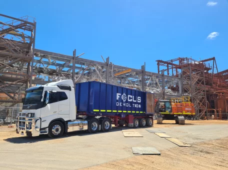 The focus demolition truck in front of the scaffolding of the Worsley Mine Site where a redundant Enhance Sands structure is being demolished.