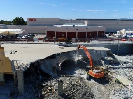 Commercial site demolition project undertaken by Focus Demolition in Perth showing a excavator in work surrounded by rubble.