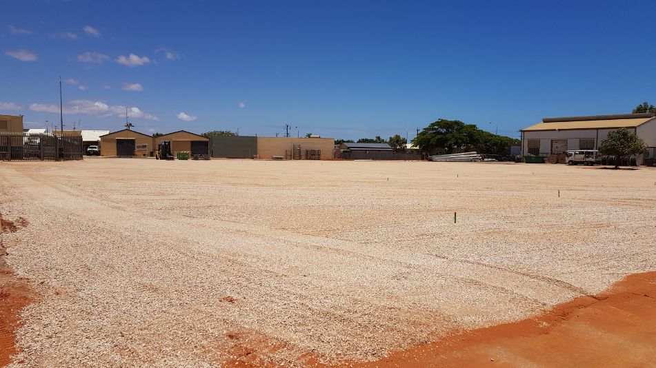 The land of the Carnarvon Power Station after decommissioning, demolition and soil remediation showing red soil.