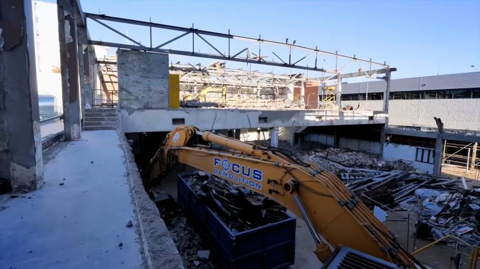 Close up of Focus Demolition equipment at work on the Fremantle high rise demolition surrounded by torn down materials and rubble