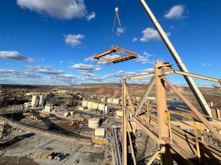 Crane moving steel at the full demolition of redundant fine ore bins and conveyor system at KCGM Goldfields superpit.