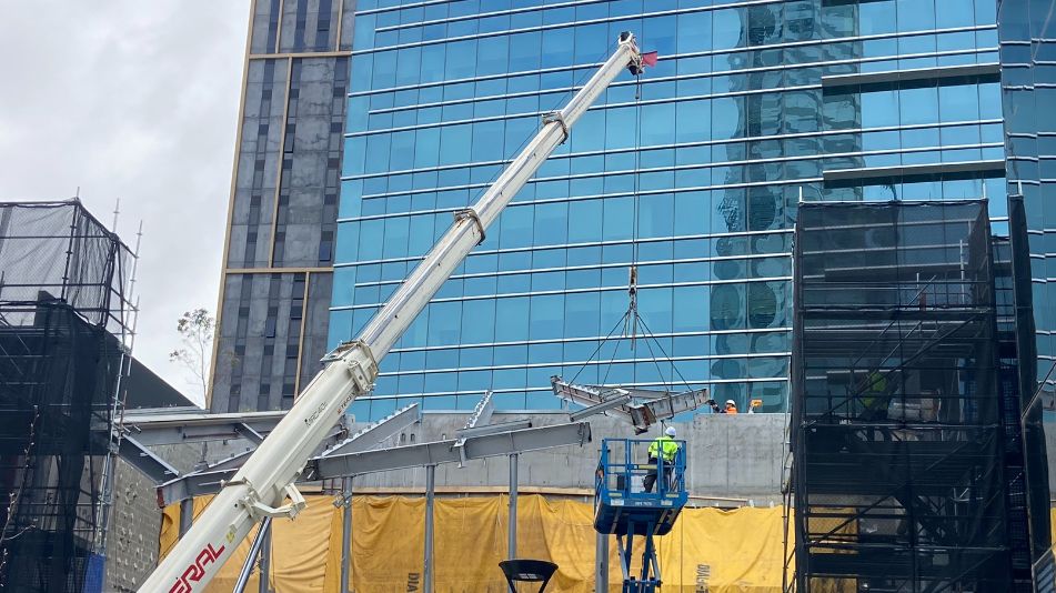 Crane moving steel parts as part of a high rise demolition project of Raine Square in Perth by Focus Demolition